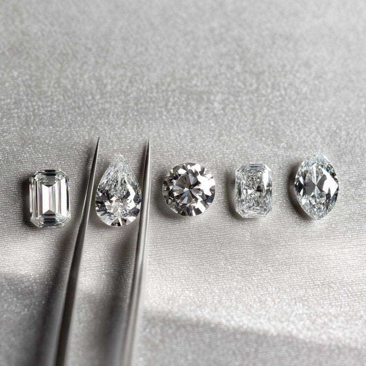 Loose diamonds in tweezers